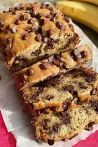 Delicious slice of chocolate chip banana bread on a wooden table
