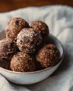Homemade chocolate peanut butter protein balls on a white plate