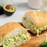 Creamy chicken sandwich topped with fresh ingredients and served on a toasted bun.