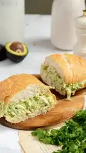 Creamy chicken sandwich topped with fresh ingredients and served on a toasted bun.