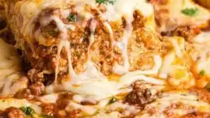 Effortless no-boil lasagna topped with cheese and herbs in a baking dish