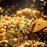 Plate of flavorful fried rice with vegetables and protein