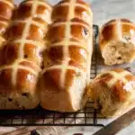 Freshly baked Hot Cross Buns cooling on a wire rack