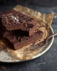 No Bake Chocolate Protein Bars 3 No bake chocolate protein bars on a plate with ingredients