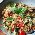 Bright and healthy quinoa salad featuring fresh vegetables and herbs
