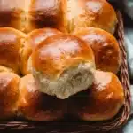 Soft and fluffy dinner rolls on a wooden table
