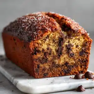 banana chocolate chip cake hero shot 45 degree angle on bright table