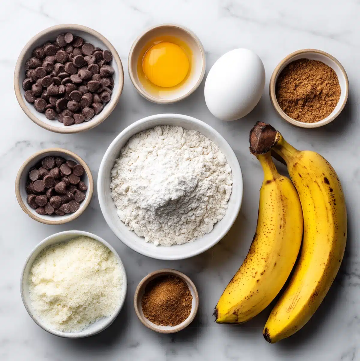 banana chocolate chip muffins ingredients flat lay with Kodiak mix, eggs, milk, and ripe banana on a wooden board