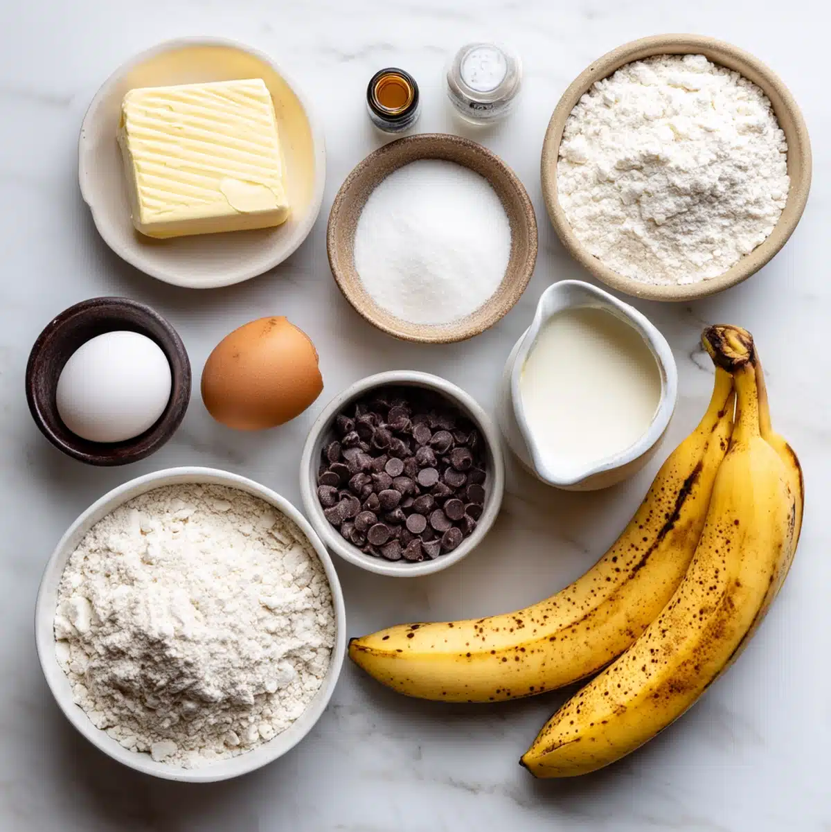 banana chocolate chip scones ingredients flat lay with frozen butter and ripe bananas