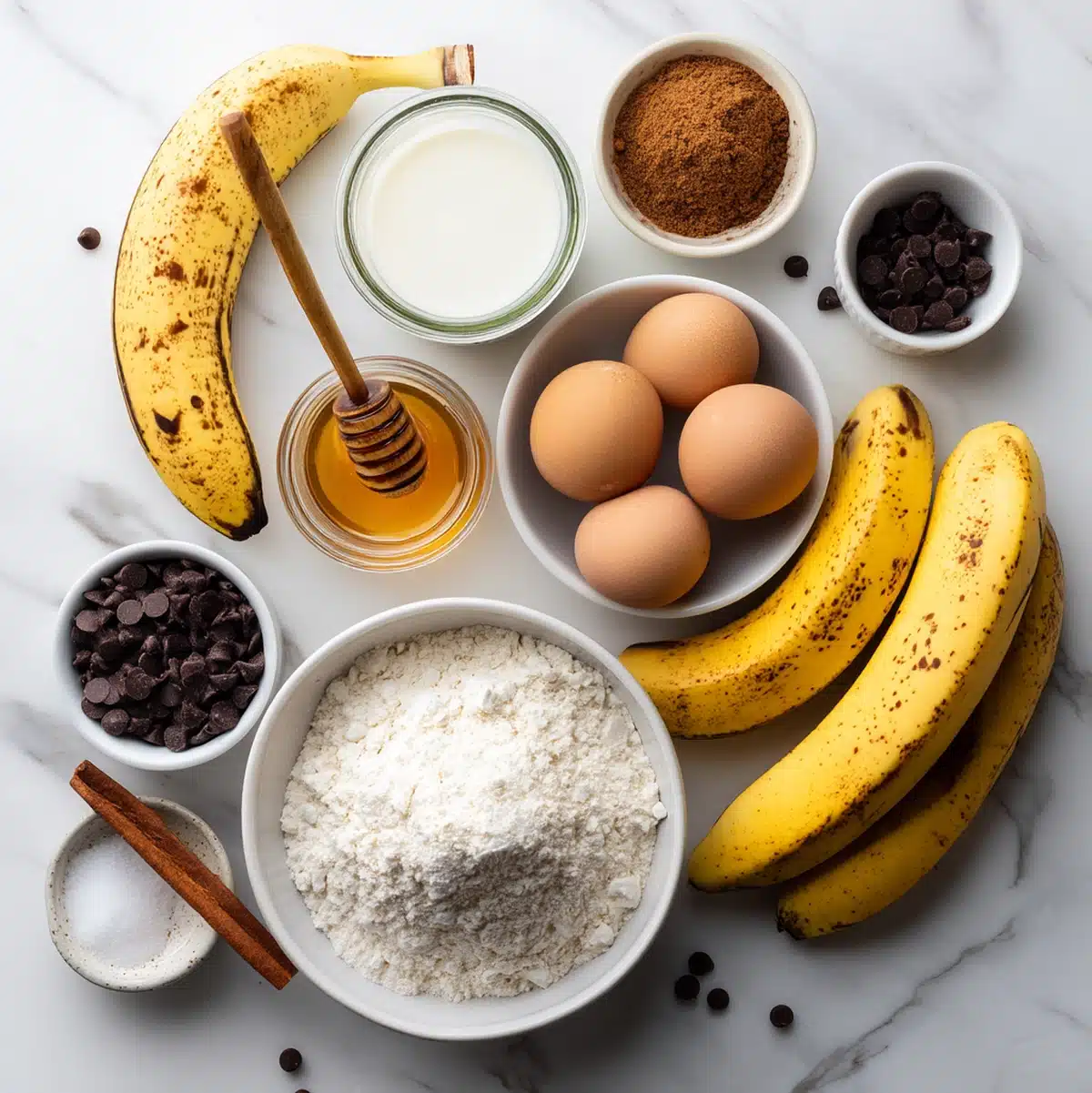 healthy banana chocolate chip bread ingredients flat lay with ripe bananas and chocolate chips