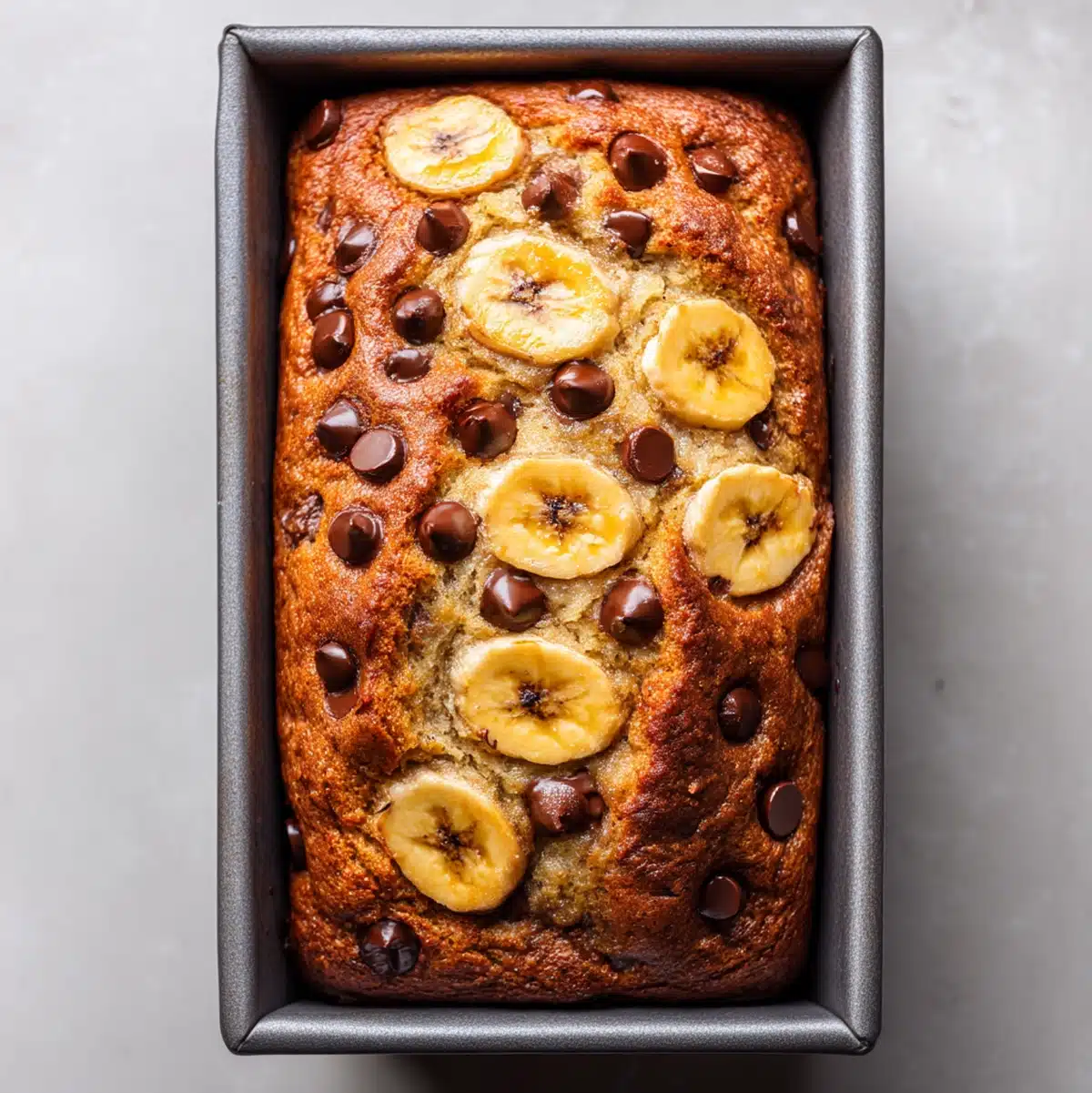 healthy banana chocolate chip bread baking with melted chocolate chips on top