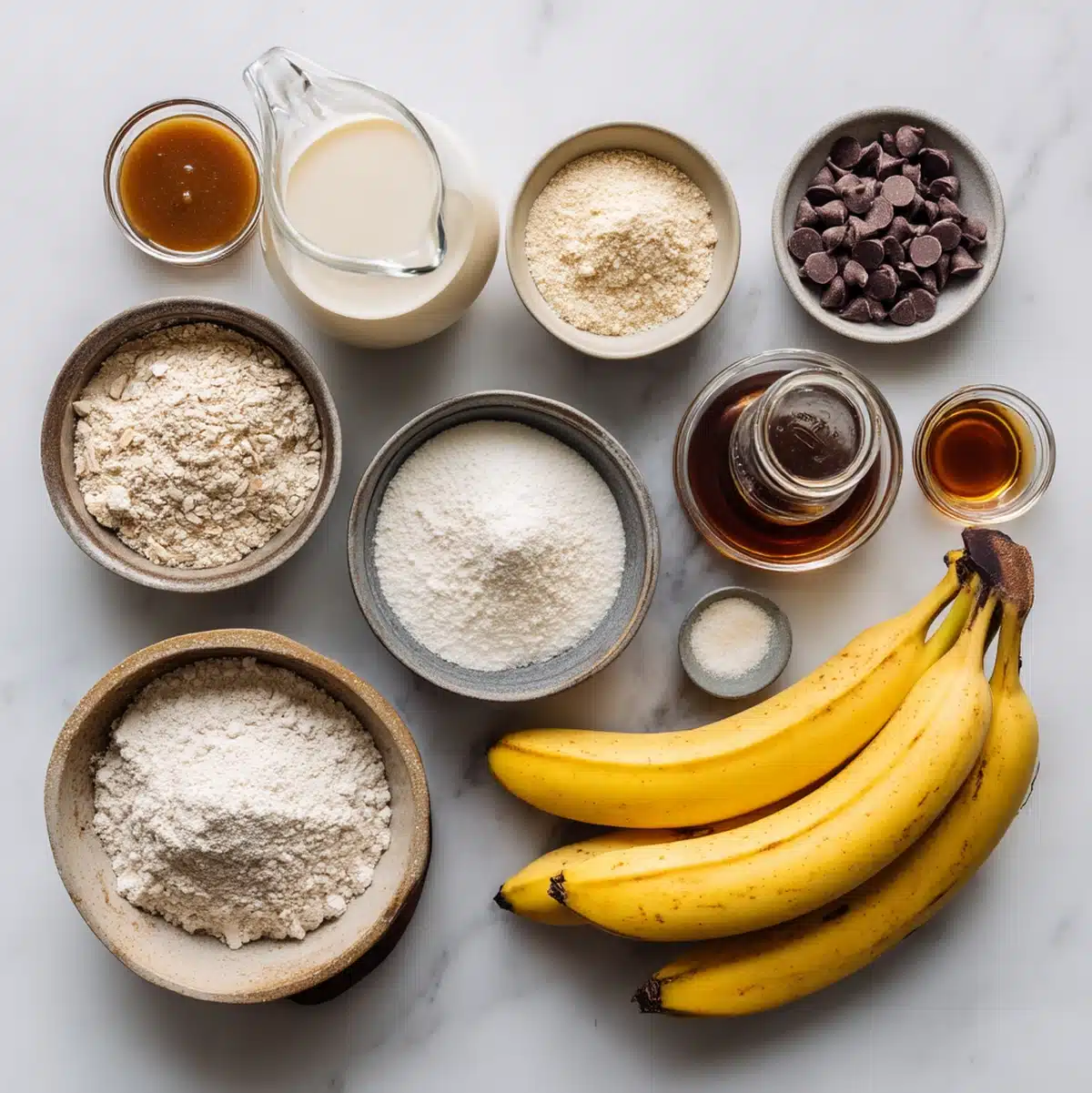 Vegan banana chocolate chip muffins ingredients flat-lay with ripe bananas and dairy-free chocolate chips