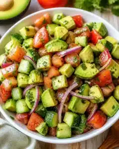 Fresh Avocado Salad with colorful vegetables and dressing
