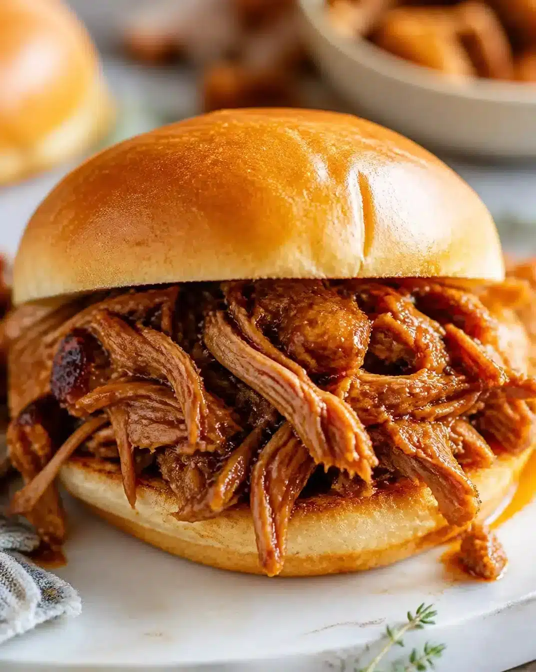 Delicious slow-cooker pulled pork served in a bun with barbecue sauce
