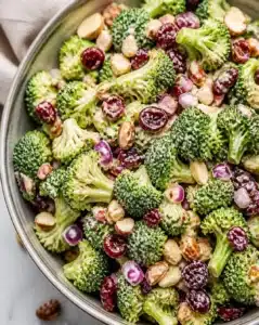 Healthy broccoli salad with nuts and cranberries in a bowl