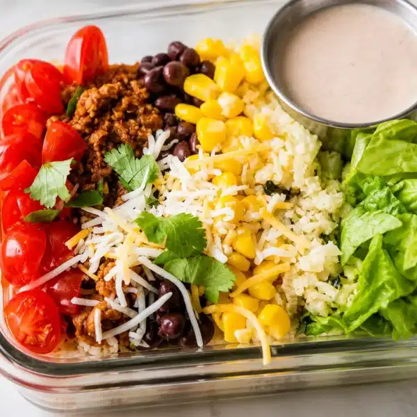 Healthy taco bowl meal prep with lean protein, veggies, and flavorful toppings.