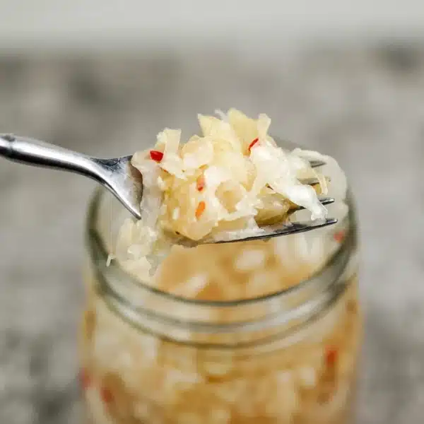 Homemade fermented cabbage sauerkraut with vibrant colors and probiotics.