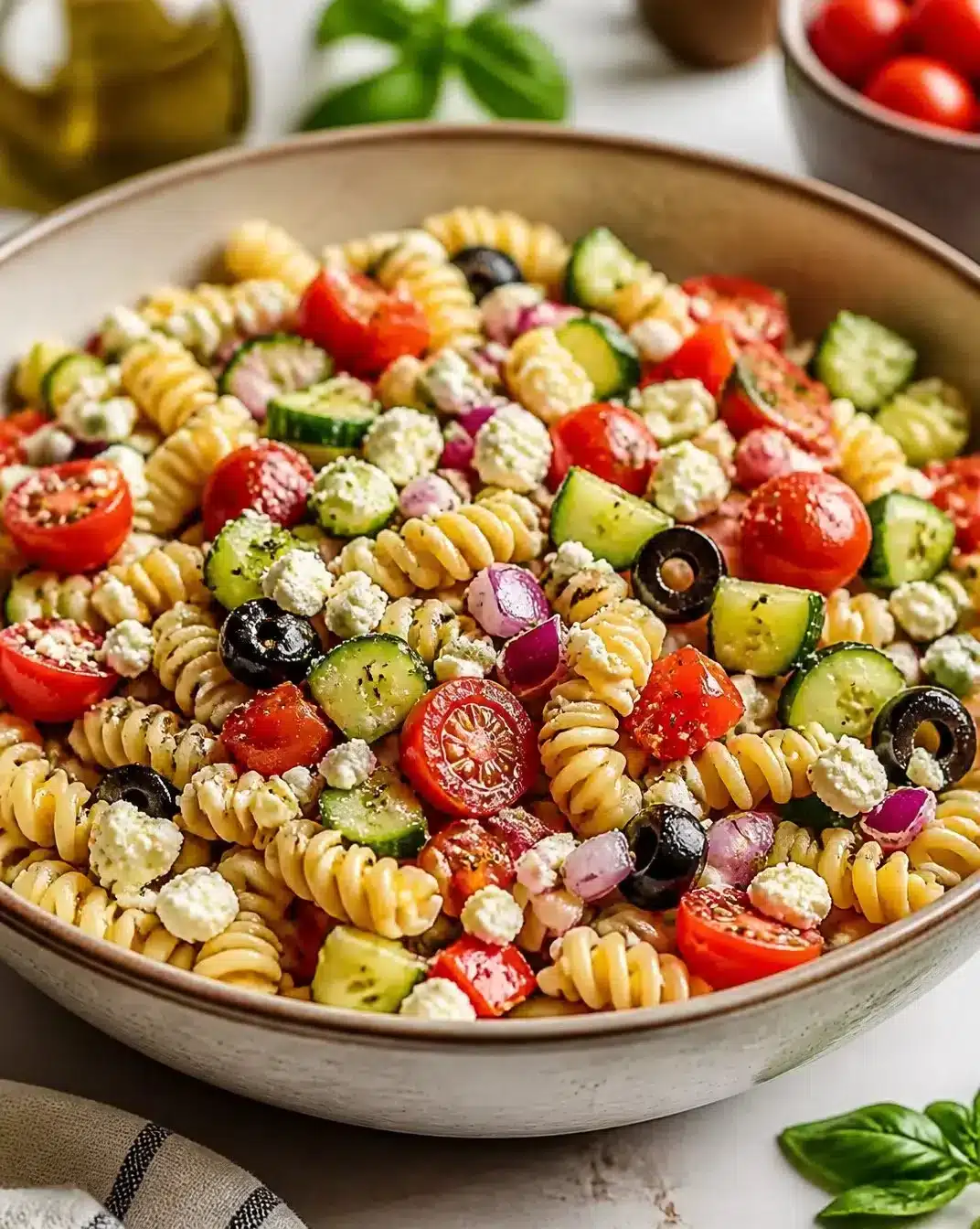 Bowl of colorful pasta salad with vegetables and dressing