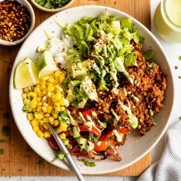 Healthy taco bowl meal prep with lean protein, veggies, and flavorful ingredients.