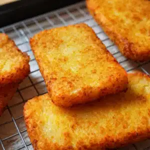 Crispy homemade McDonald's hash browns served on a plate.
