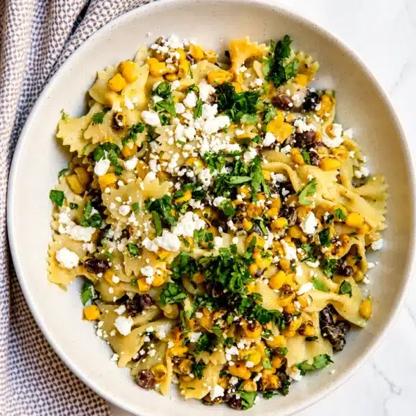 Creamy street corn pasta salad with corn, cotija cheese, and a tangy dressing.