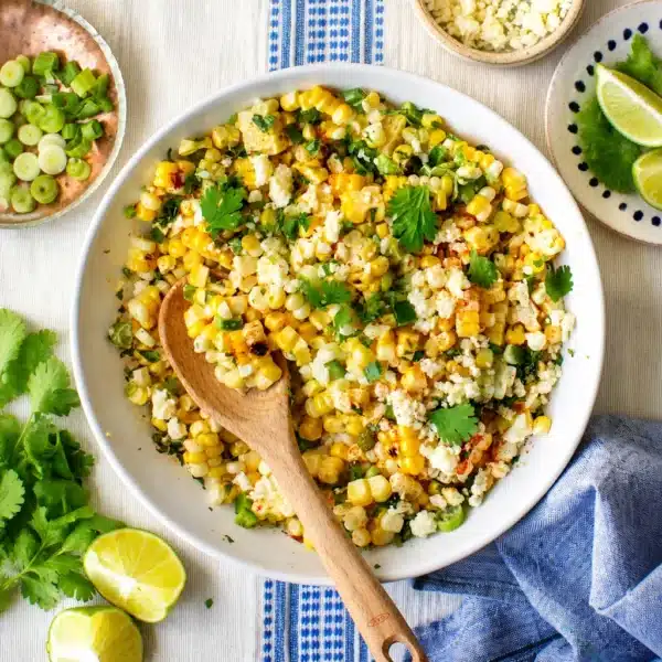 Delicious Mexican Street Corn Salad with grilled corn, mayo, lime, and spices