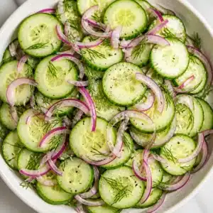 7-Minute Easy Cucumber Salad That Hits the Spot! 3 A refreshing easy cucumber salad with slices of cucumber and onions in a tangy dressing.
