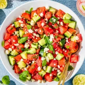 Fresh watermelon cucumber feta salad with mint and lime dressing for summer.